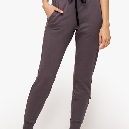 woman wearing deep purple sweatpants with drawstring 