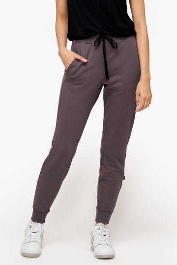 woman wearing deep purple sweatpants with drawstring 