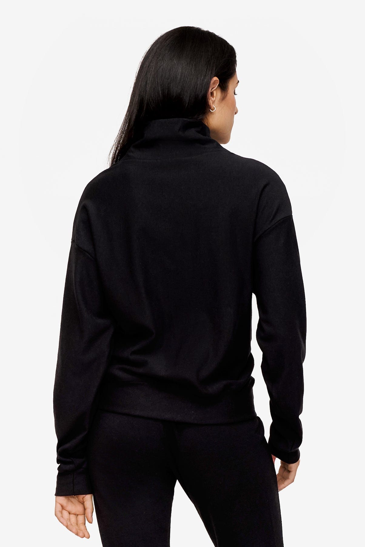 back of a woman wearing a 1/4 zip sweatshirt in black