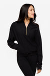 woman wearing a 1/4 zip sweatshirt in black