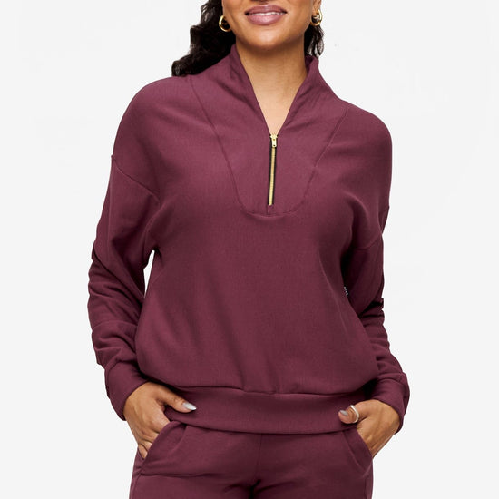 woman wearing a 1/4 zip sweatshirt in deep pink