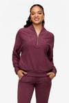 woman wearing a 1/4 zip sweatshirt in deep pink