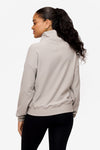 back of a woman wearing a 1/4 zip sweatshirt in grey