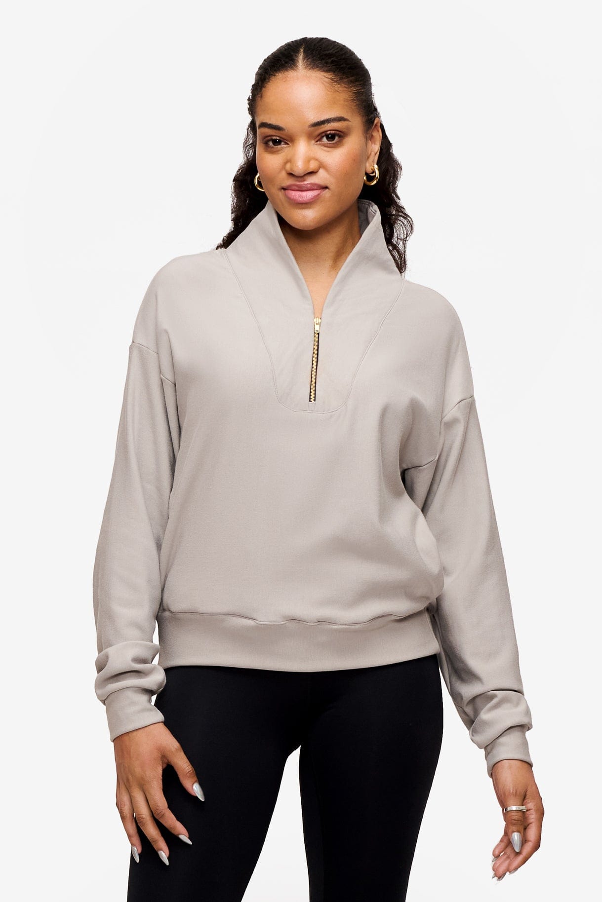 woman wearing a 1/4 zip sweatshirt in grey