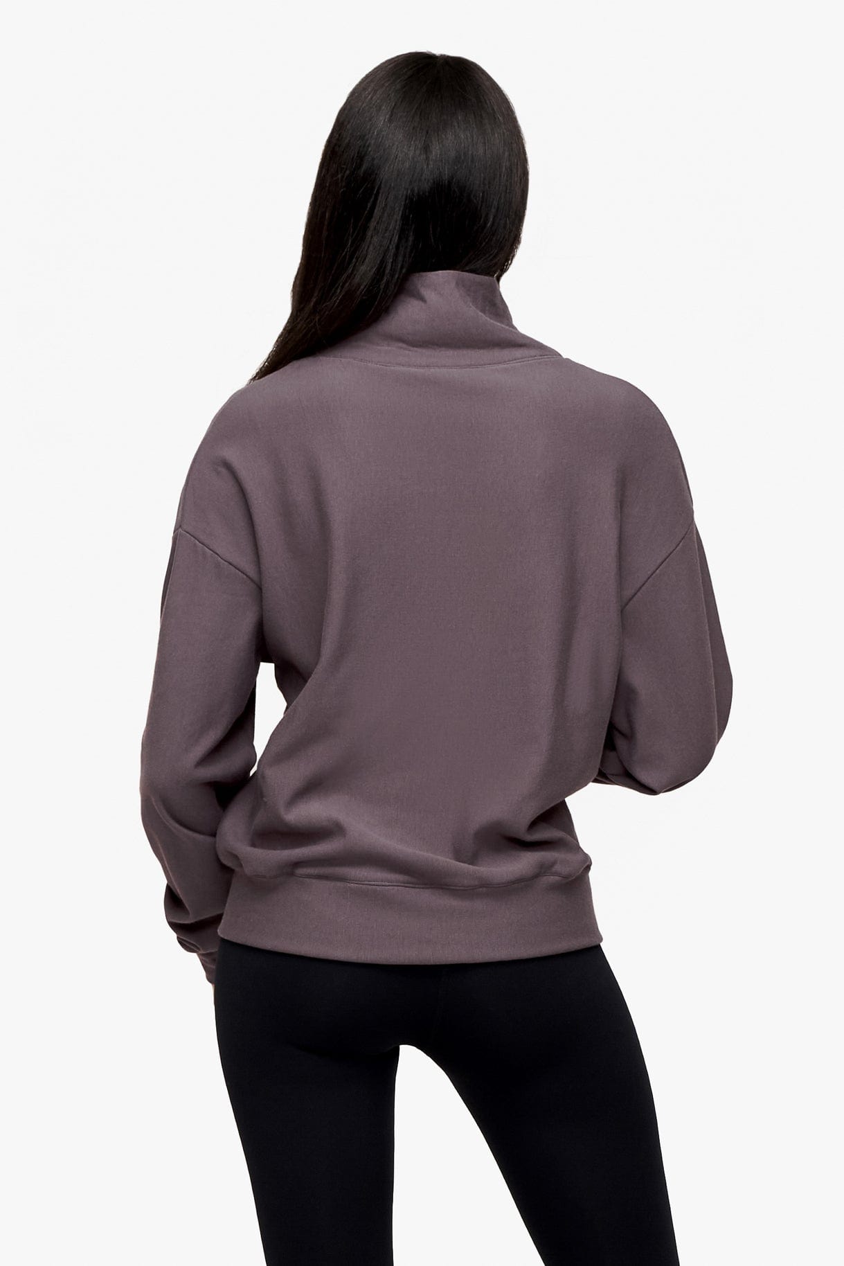 back of a woman wearing a 1/4 zip sweatshirt in deep purple