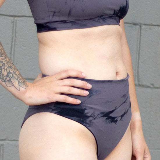 Woman wearing grey tie-dye swim bottoms