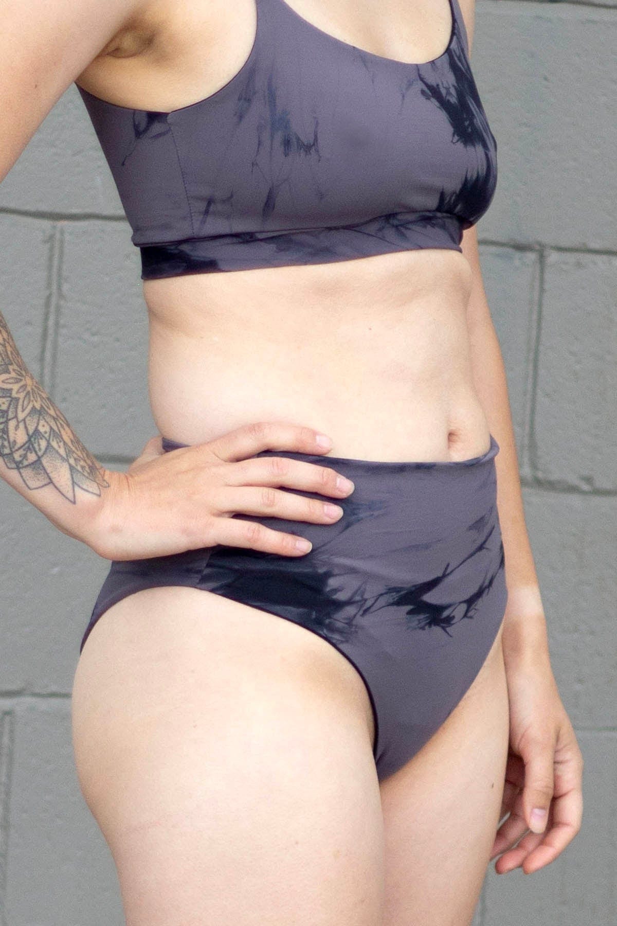Woman wearing grey tie-dye swim bottoms