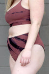 Woman wearing a pink and black tie-dye swim bottom