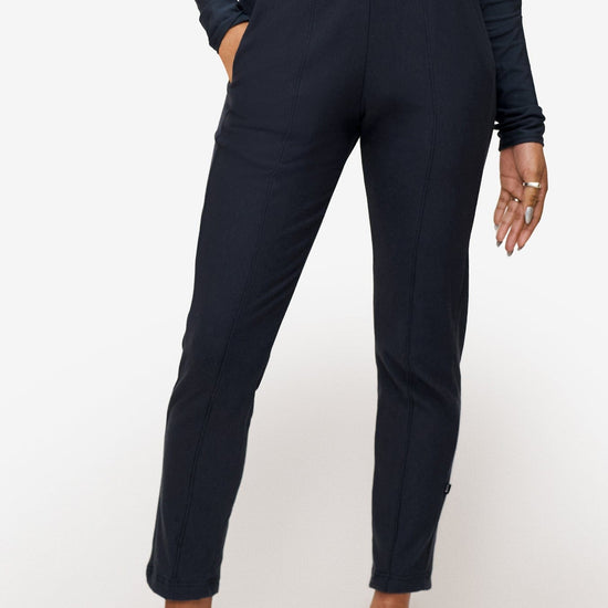 woman wearing dark blue dressy pants 