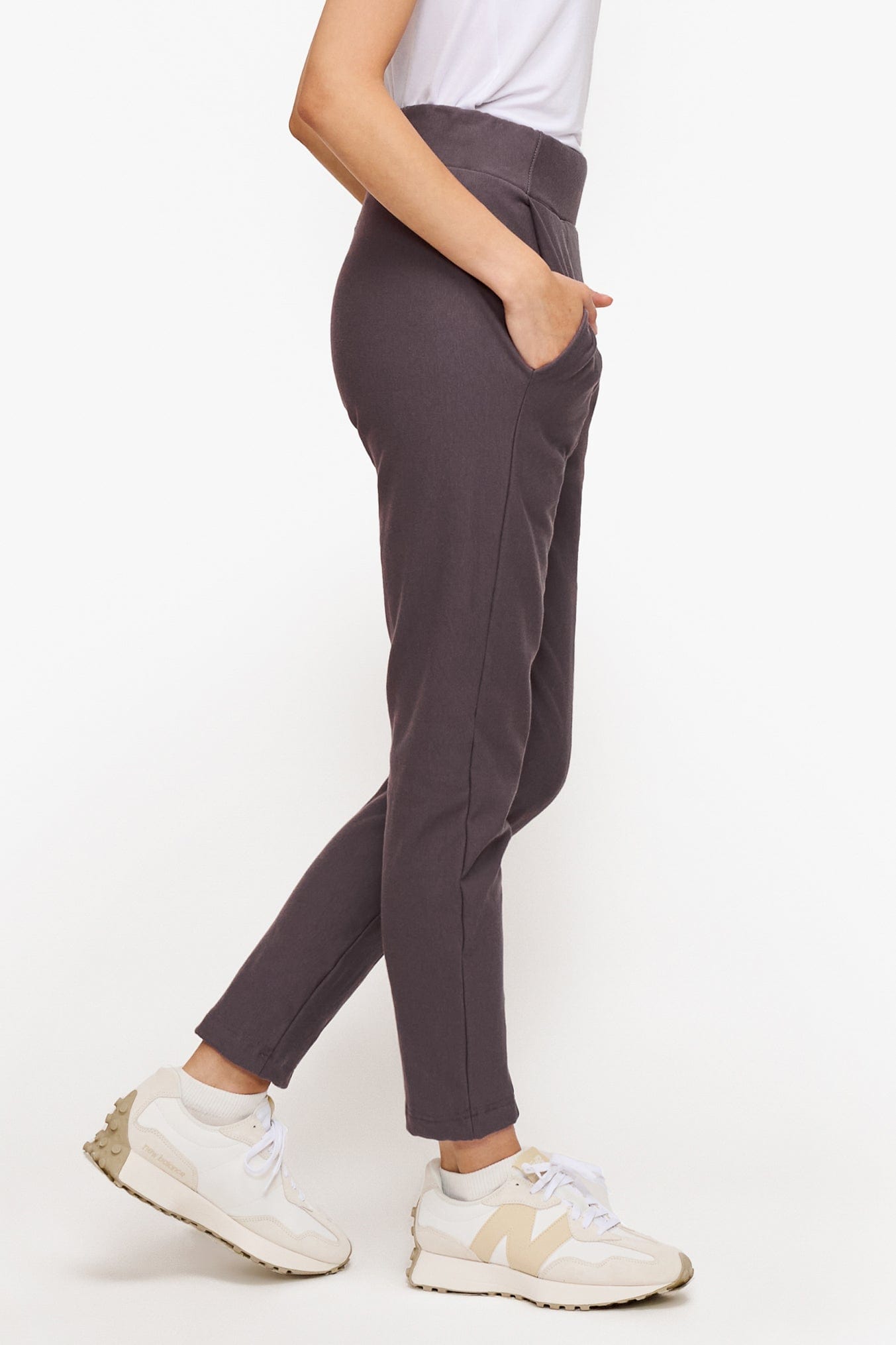 side of a woman wearing deep purple dressy pants with white top