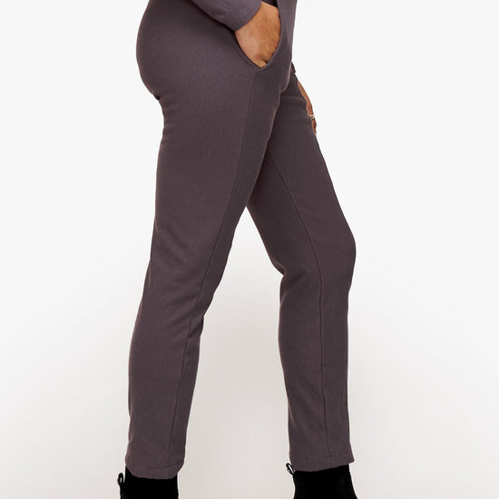 side of a woman wearing deep purple dressy pants 