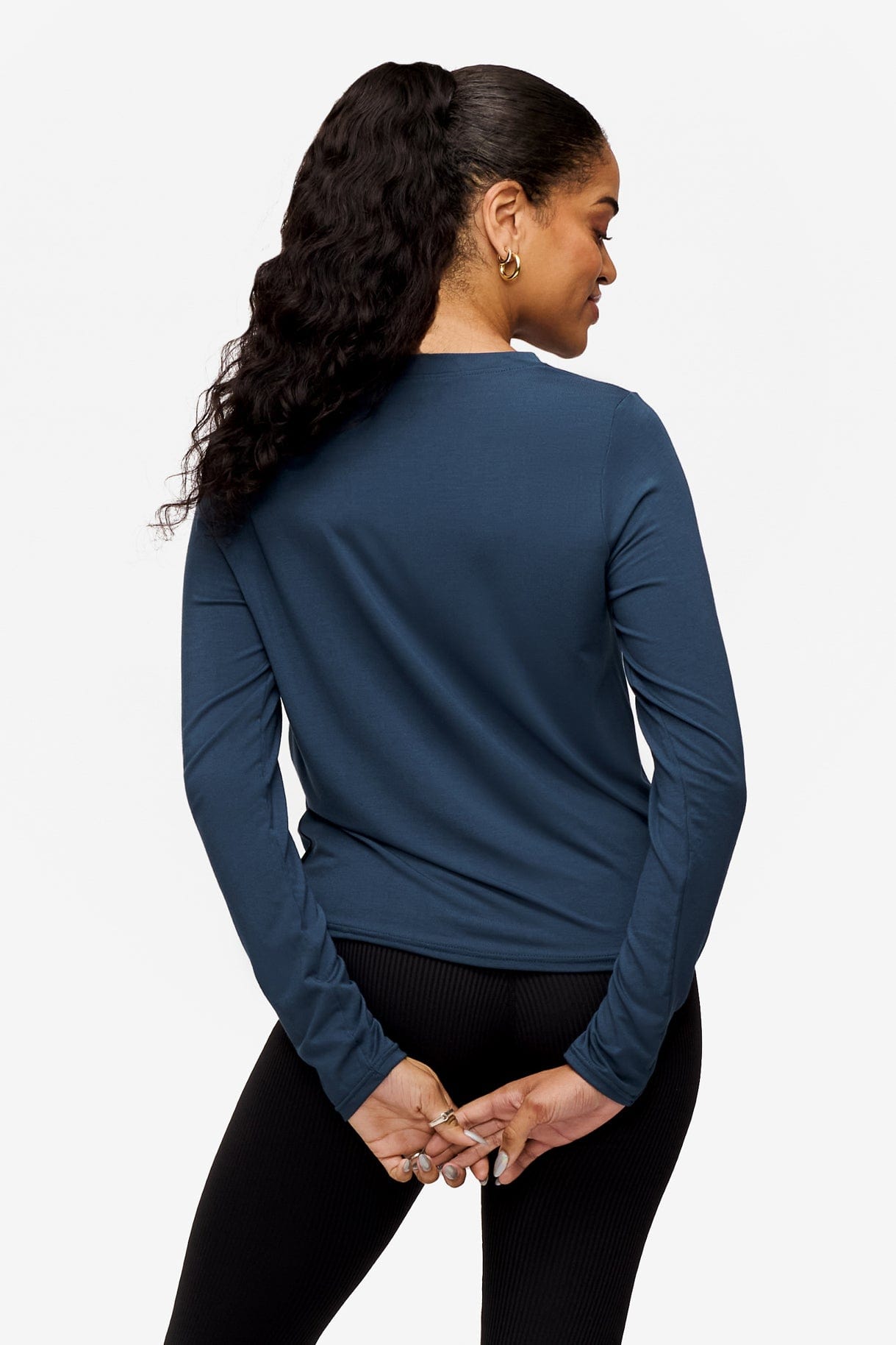 back of a woman wearing a long sleeve shirt with a twist at the front in  blue