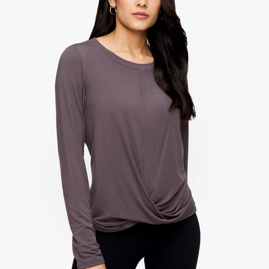 woman wearing a long sleeve shirt with a twist at the front in deep purple