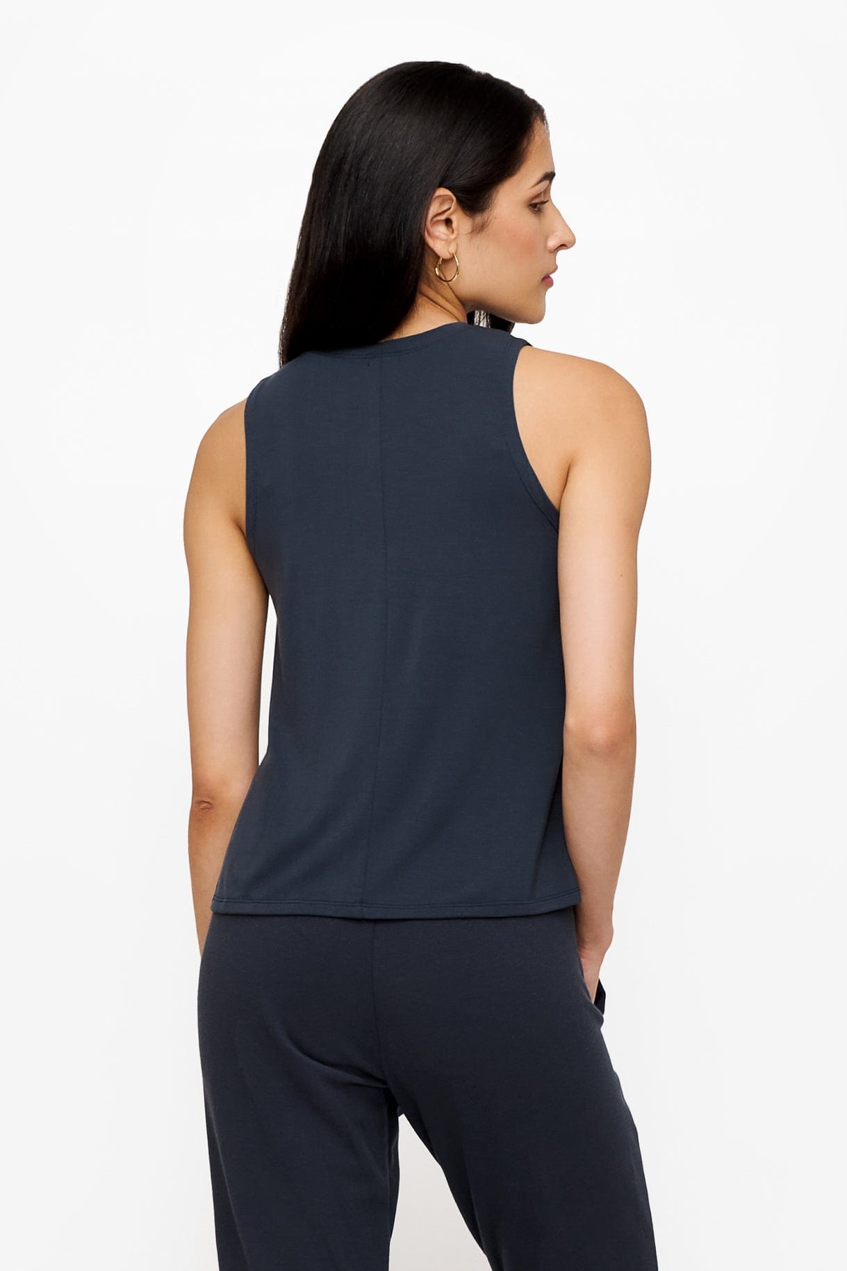 back of a woman wearing a dark blue high tank top