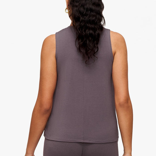 back of a woman wearing a deep purple high tank top