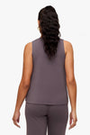 back of a woman wearing a deep purple high tank top