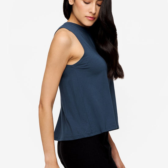 side of woman wearing a deep blue high tank top