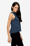 side of woman wearing a deep blue high tank top