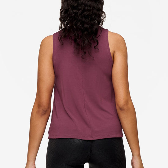 back of a woman wearing a deep blue high tank top