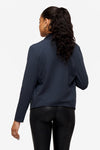 back of a woman wearing a dark blue jacket 