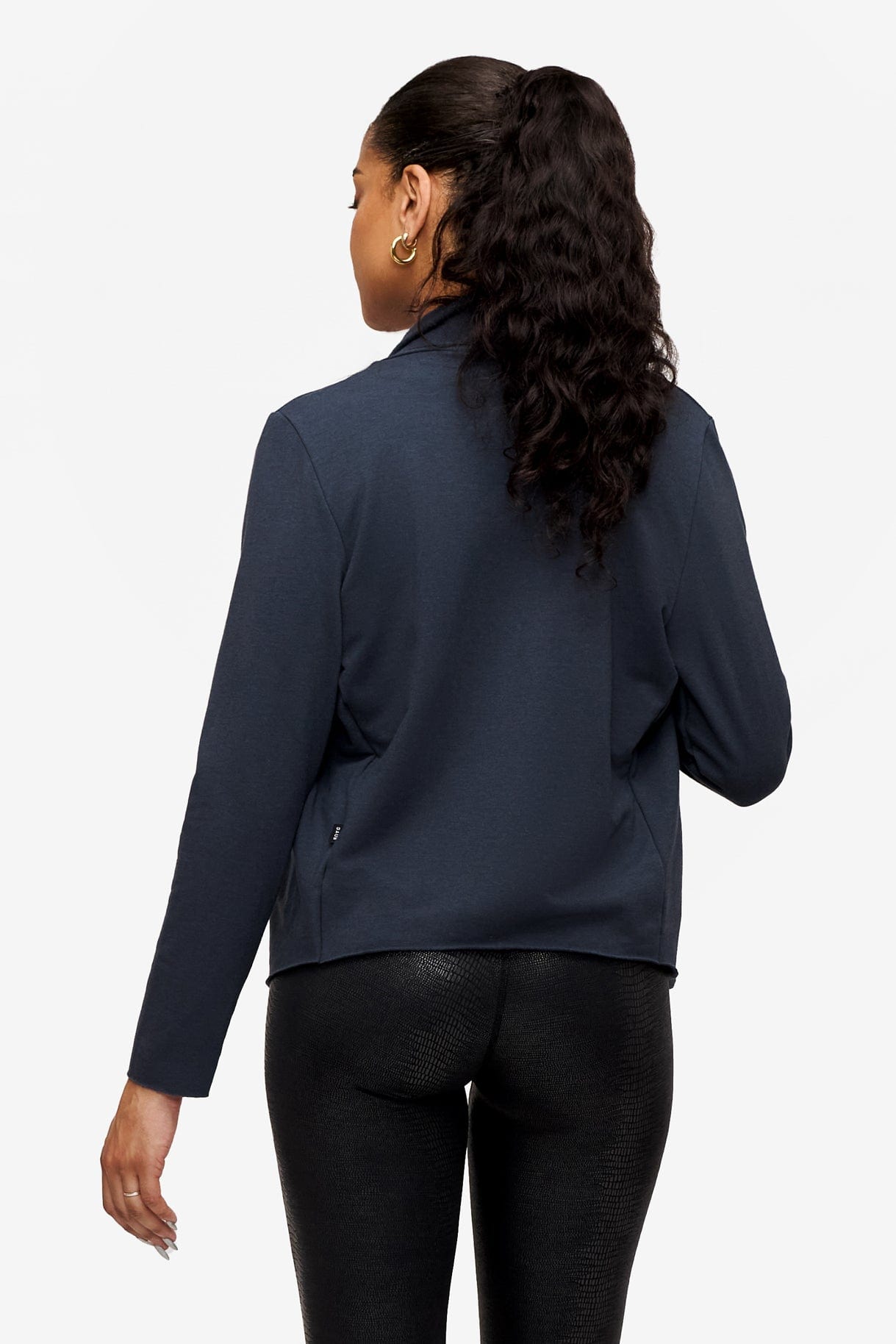 back of a woman wearing a dark blue jacket 