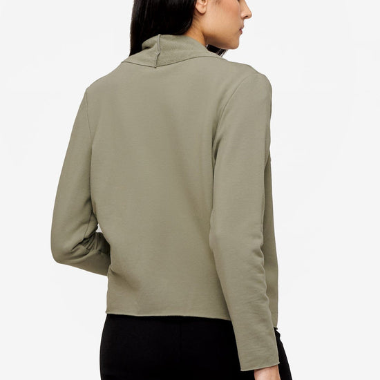 back of a woman wearing a green jacket 