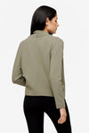 back of a woman wearing a green jacket 