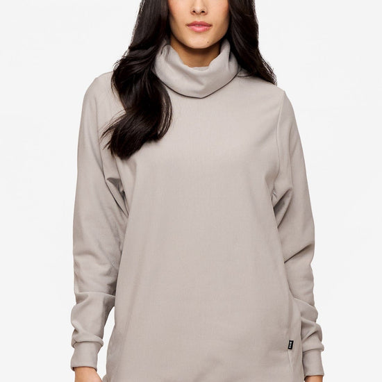 woman wearing a turtleneck sweater in light grey