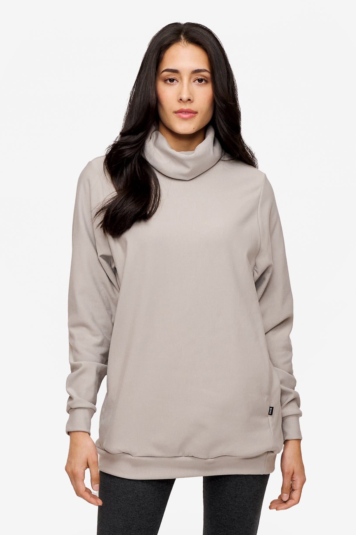 woman wearing a turtleneck sweater in light grey