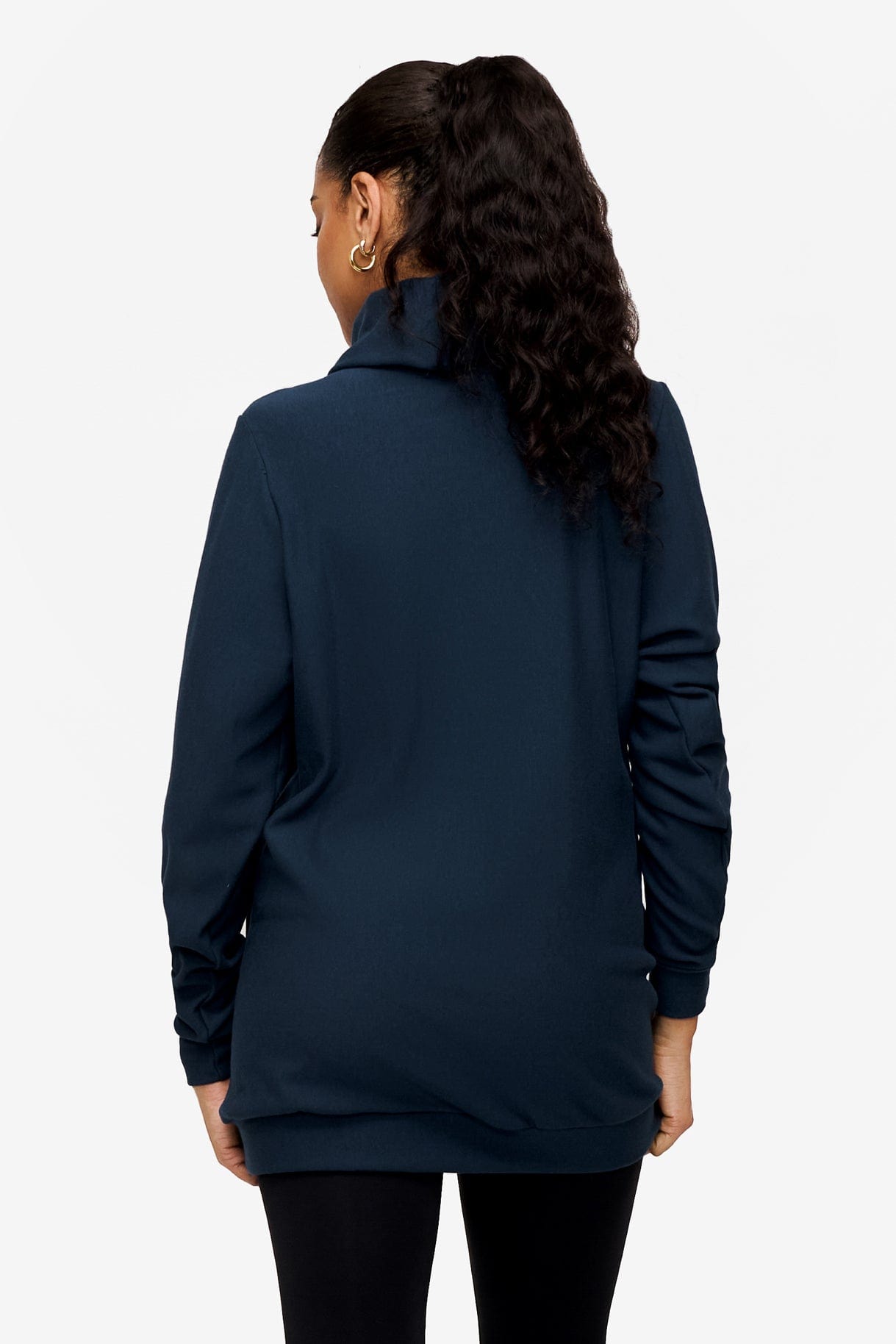 back of a woman wearing a turtleneck sweater in blue