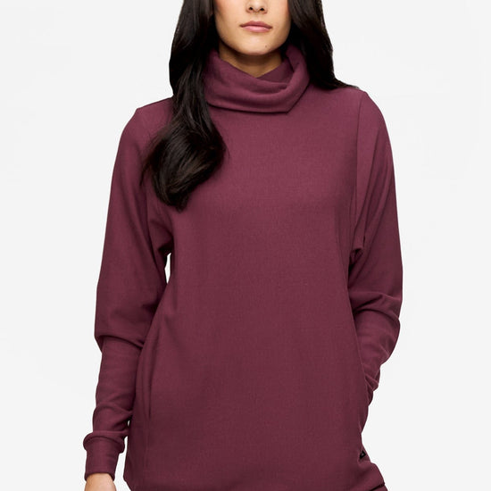 woman wearing a turtleneck sweater in deep pink