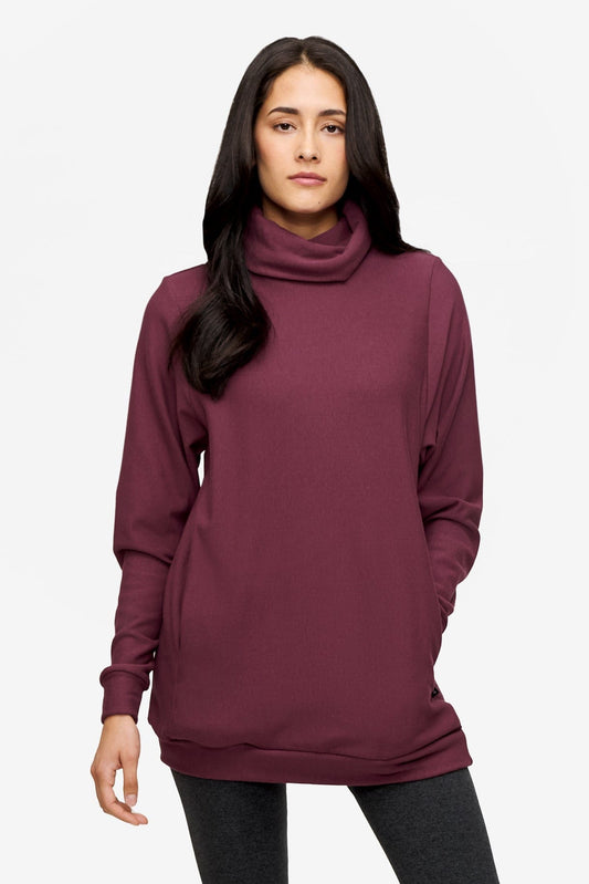 woman wearing a turtleneck sweater in deep pink