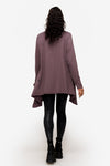 back of a woman wearing a drapey jacket in deep purple