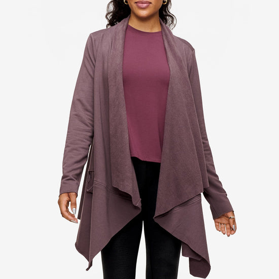 woman wearing a drapey jacket in deep purple