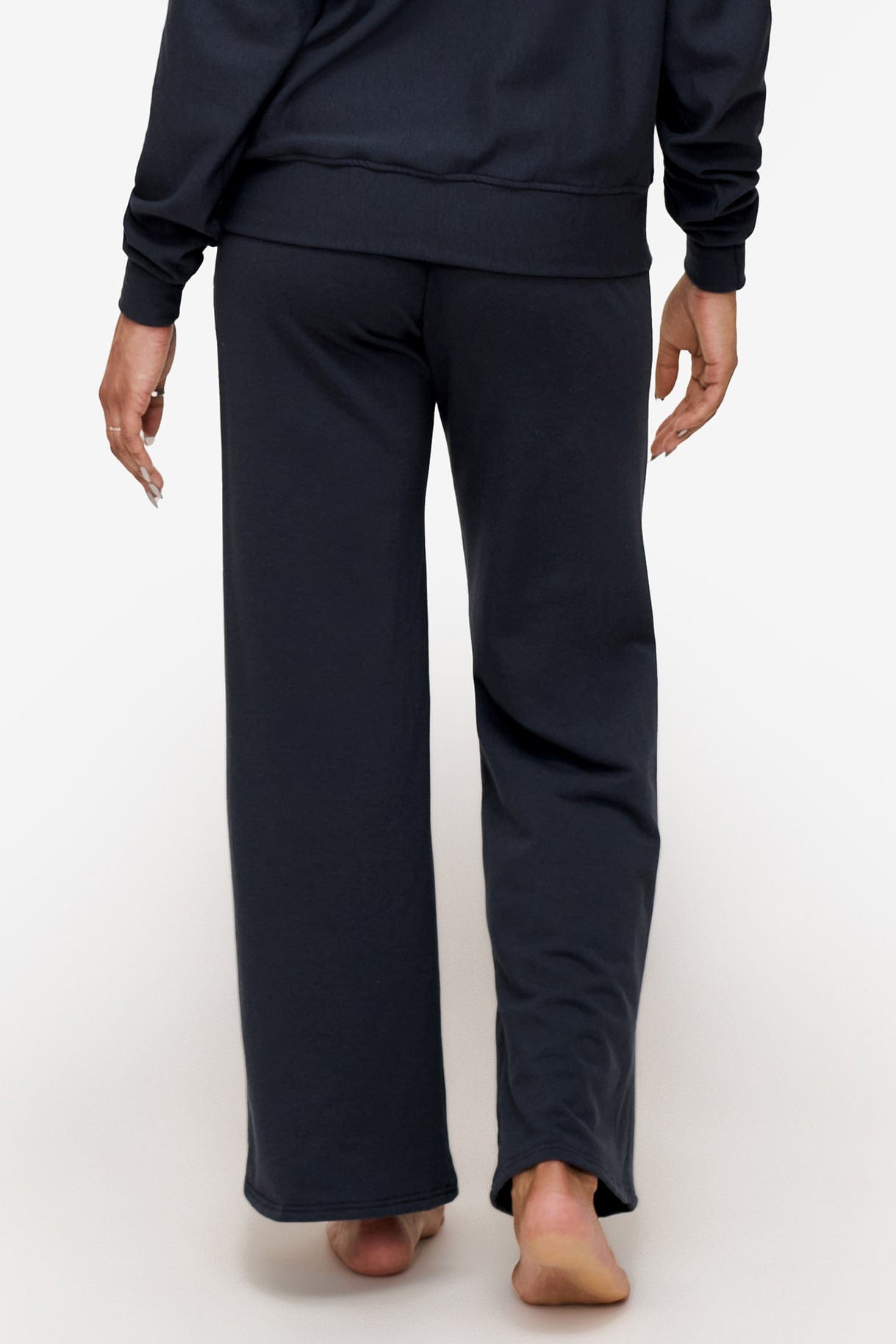 back of a woman wearing deep blue wide leg sweatpants 