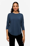 Woman smiling wearing a bright blue 3/4 sleeve shirt