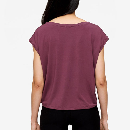 back of a woman wearing a sleeveless top in deep pink

