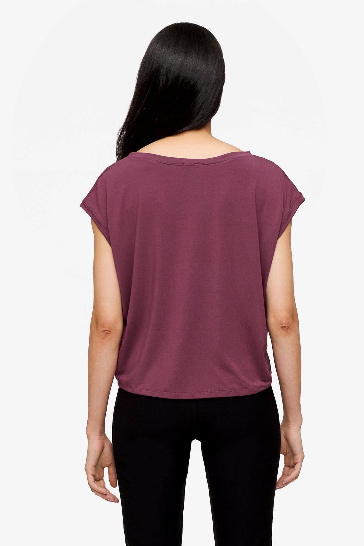 back of a woman wearing a sleeveless top in deep pink
