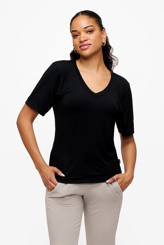 woman wearing black v-neck short sleeve t-shirt with grey pants