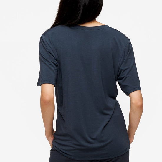 back of a woman wearing dark blue v-neck short sleeve t-shirt