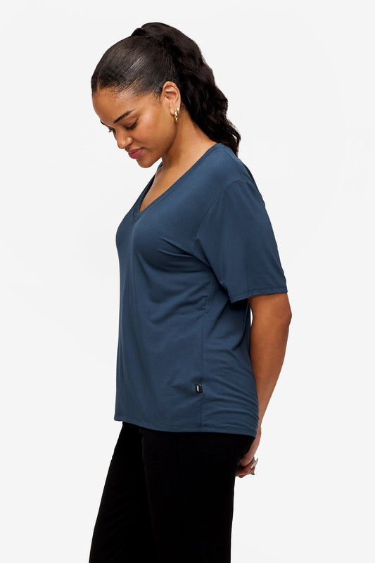 side of a woman wearing blue v-neck short sleeve t-shirt