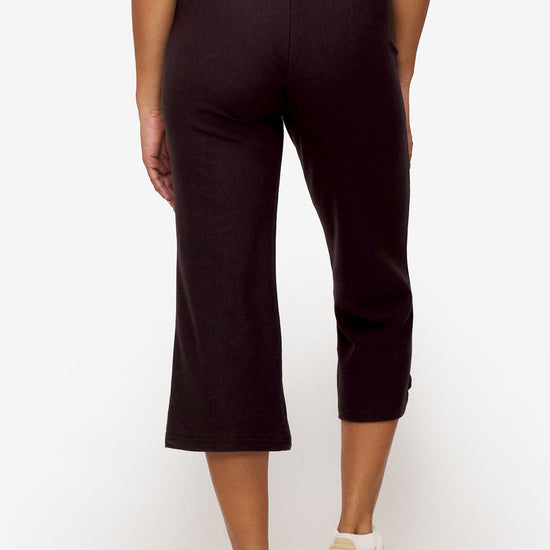 back of a woman wearing brown cropped sweatpants with drawstring 