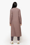 back of  a woman wearing a long front open jacket in beige
