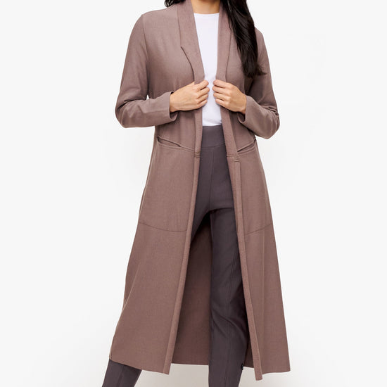 woman wearing a long front open jacket in beige