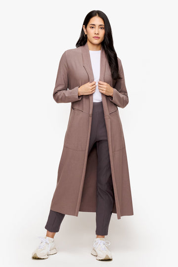 woman wearing a long front open jacket in beige
