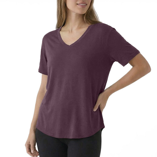 Woman wearing a purple t-shirt and black pants on a white background