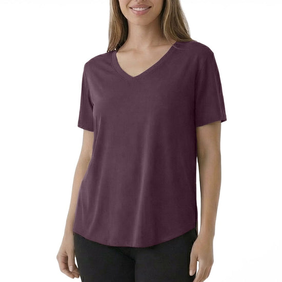 Woman wearing a purple t-shirt and black pants on a white background