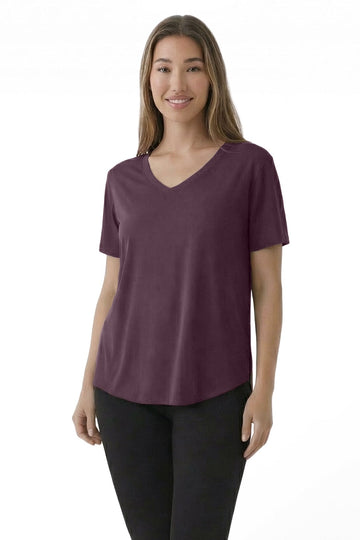 Woman wearing a purple t-shirt and black pants on a white background