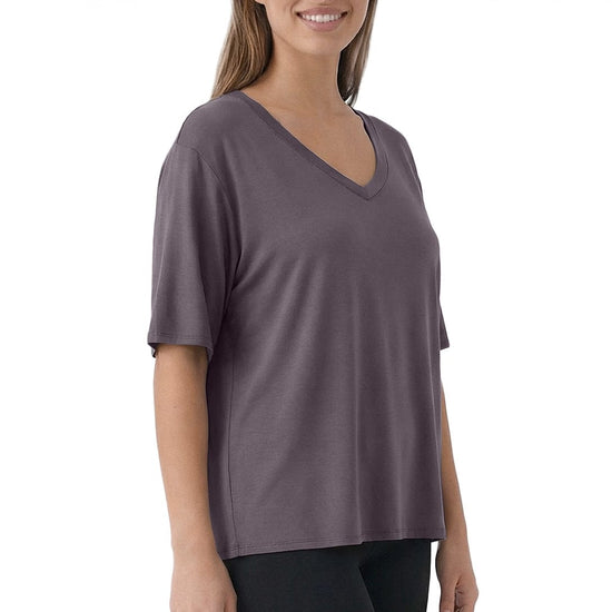 Woman wearing a purple V-neck shirt on a white background