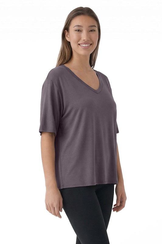 Woman wearing a purple V-neck shirt on a white background